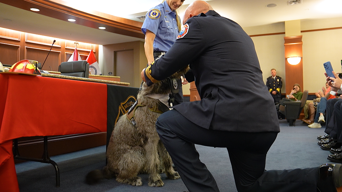 Chief Leech placing badge around Rigs neck