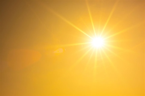 Bright summer sun with orange sky background