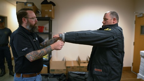 Melbourne Firefighter being measured for new turnout gear