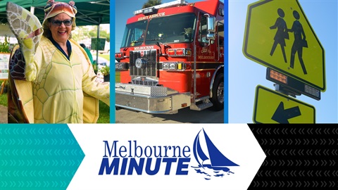 Woman in sea turtle costume, front of heavy rescue vehicle, pedestrian crossing sign text that says Melbourne Minute