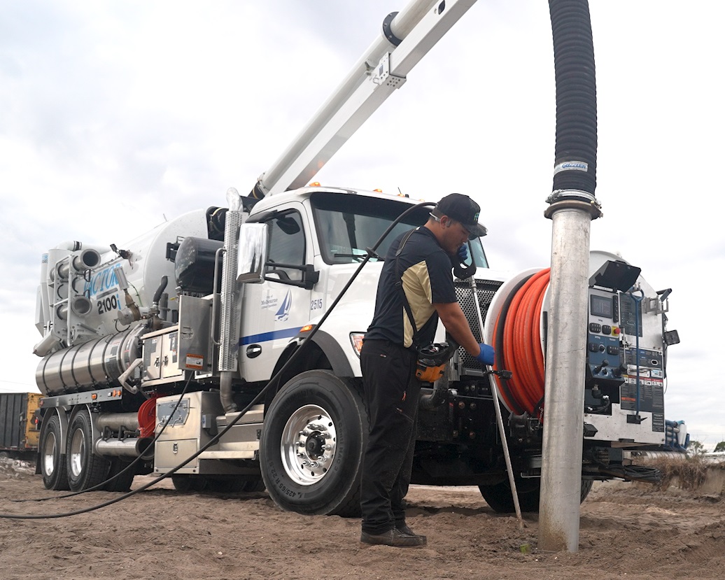 Vacuum truck and employee using it for controlled digging