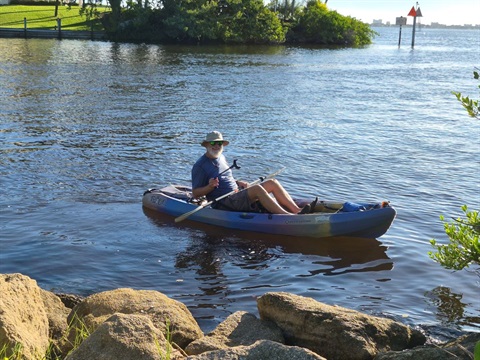 Man in kayak with pickers near the Indian River Lagoon shoreline at Ballard Park