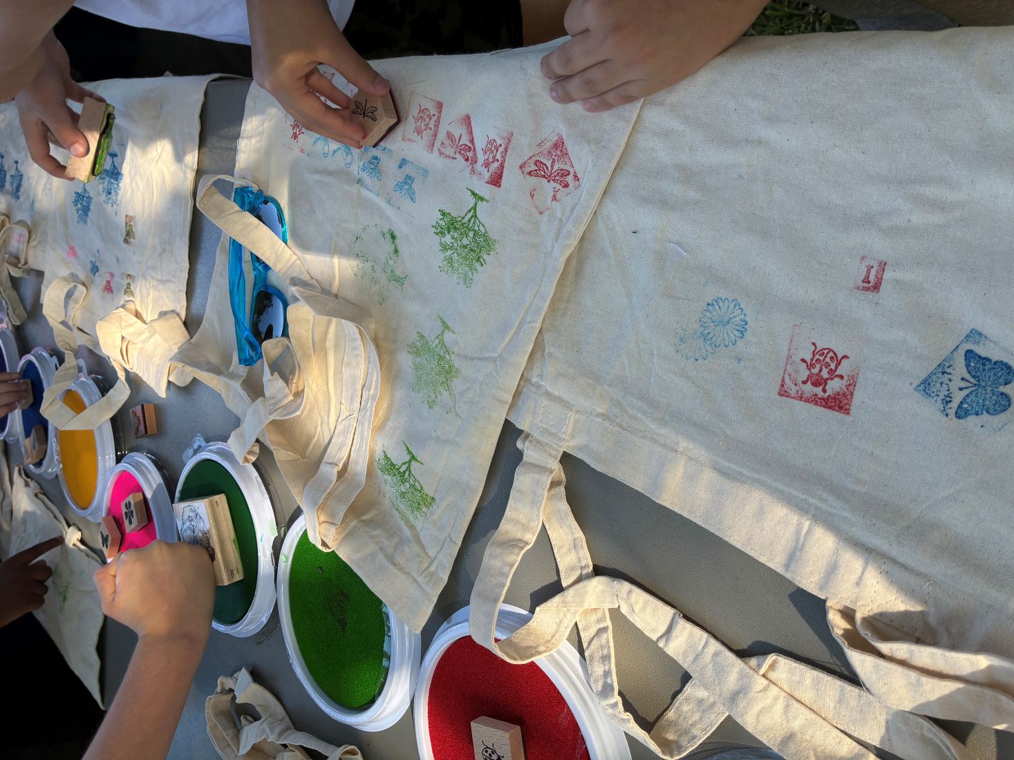 Children putting decorative stamps on aprons
