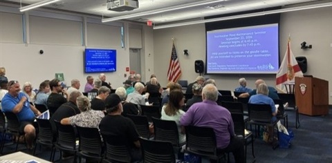 Attendees watching a presentation at the Stormwater Pond Maintenance Seminar
