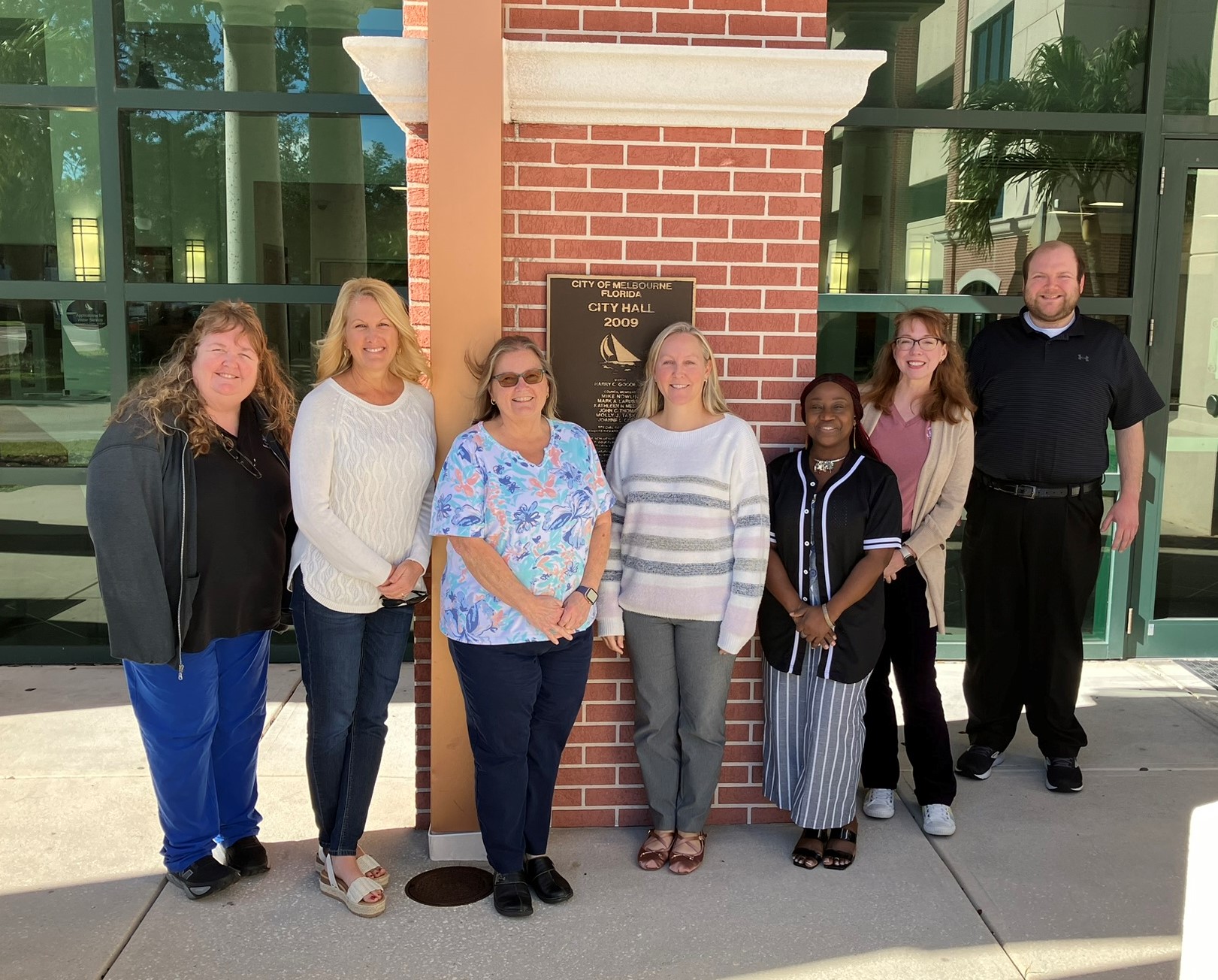 City of Melbourne Finance Department team members standing in front of City Hall