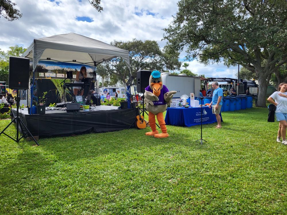 Miranda Realino on stage with Pelly the mascot dancing nearby at IRL Day