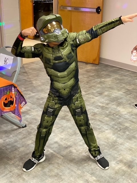 Child in Halloween costume dancing