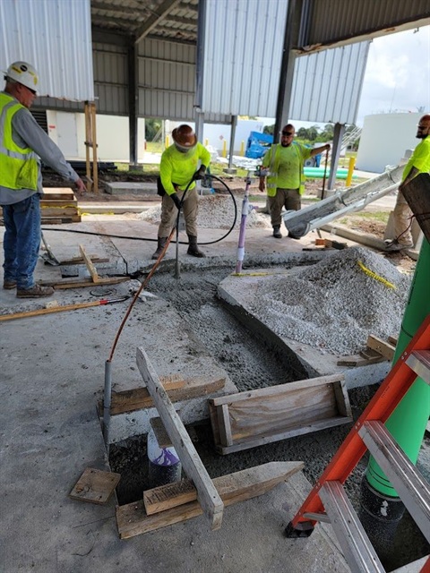 Men pouring concrete in the area of the sludge thickeners at Grant Street WWTP
